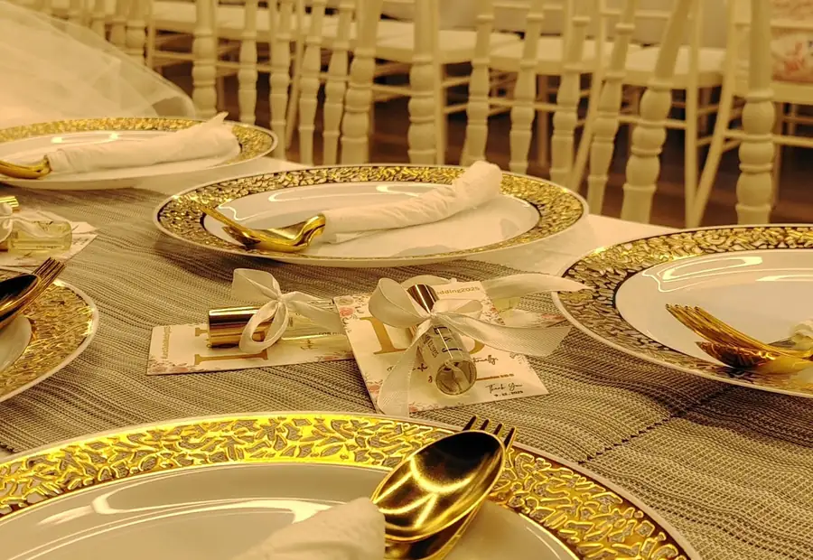 Gold place settings on a banquet table